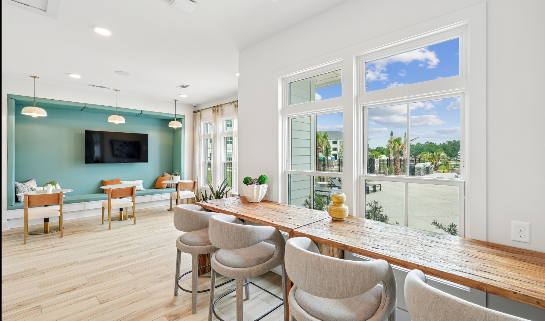 Lobby with ample lounge seating, multiple windows, and a tv. 